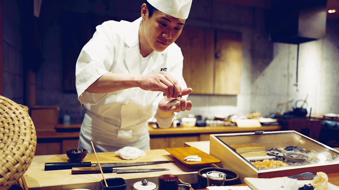 A Japanese chef prepares sushi