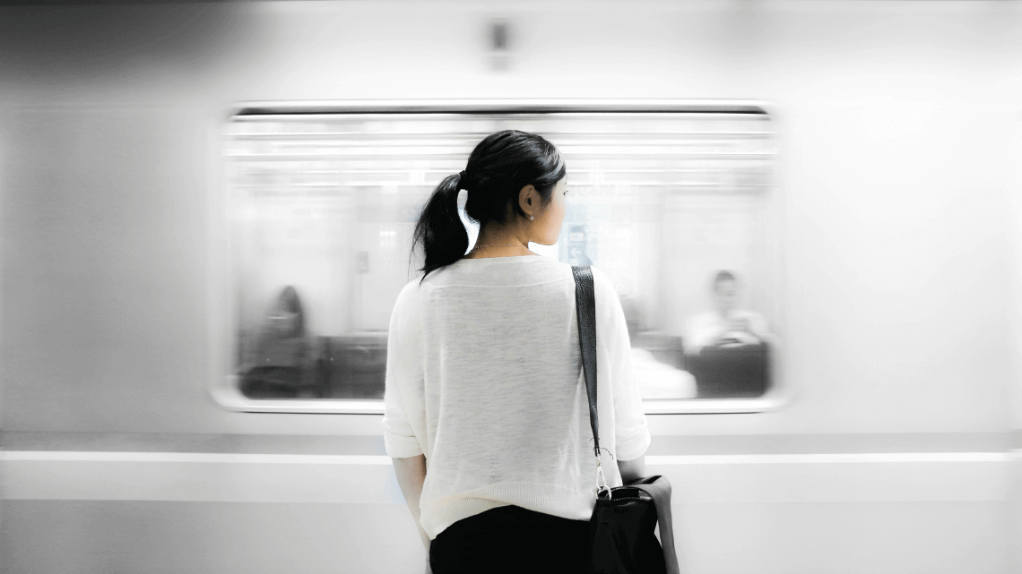 A woman waits for a train in the Tokyo metro, Japan